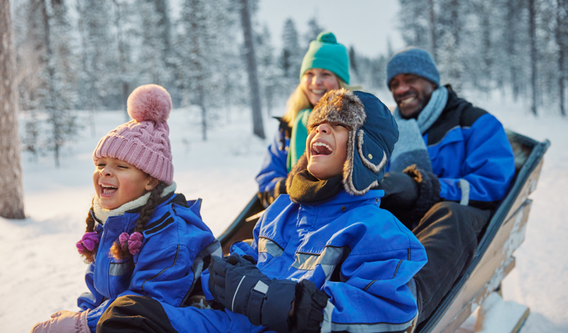 Family enjoying a Santa’s Magic Lapland short break in the snow