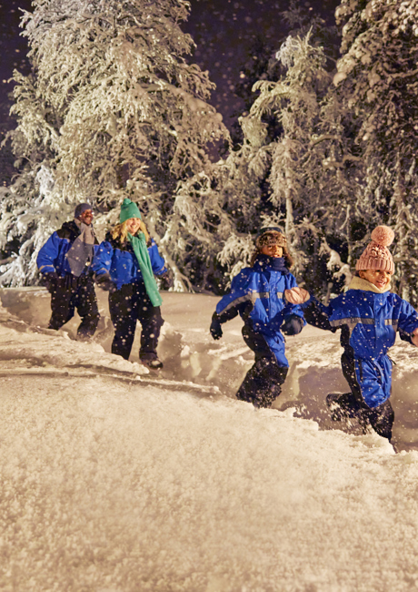 family running through the snow